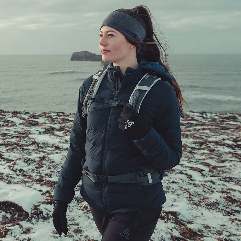 A woman wearing a hiking jacket